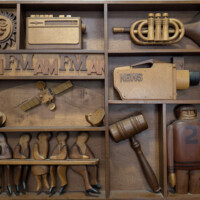 The sun, and antique symbol of good fortune<br>
Transistor radio<br>
Trumpet: Symbol of broadcast music<br>
AM/FM radio<br>
Television mini-cam<br>
Satellite and satellite dish<br>
WBA board and committee function<br>
Legal issues<br>
Sports reporting