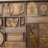 American principles honored<br>
Cathedral-style radio, carbon microphone<br>
Headset for engineering<br>
Television Code<br>
Mask of Comedy, Tragedy<br>
Rooster: Symbol of broadcasting as sentinel<br>
Broadcast news<br>
Stop watch: Symbol of deadlines<br>
Instruction, a broadcasting fundamental<br>
Audio sound board<br>
Enrichment, a broadcasting fundamental<br>
Ballet: Symbol of cultural coverage<br>
Television weather symbols<br>
UHF/VHF<br>
Basketball: Symbol of sports coverage